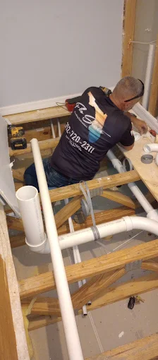 Flo State plumber running new PVC lines during a whole-home repipe